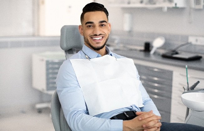 Patient smiling while sitting in treatment chair