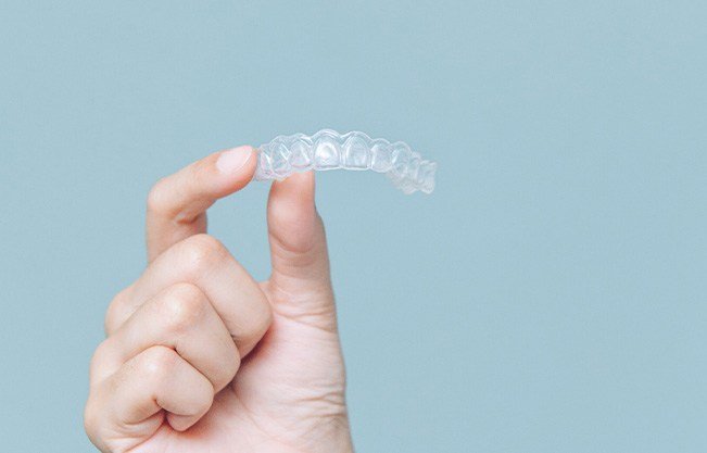 Patient holding clear aligner