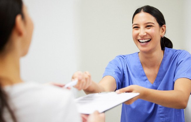 Patient in Covington talking to dental team about cosmetic dentistry