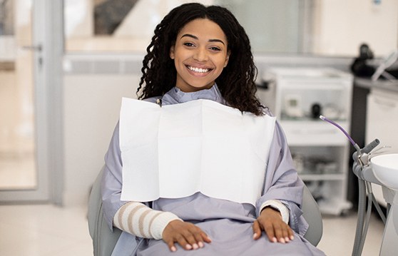 Woman sitting in a dental chair and smiling