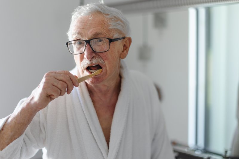 Patient cleaning their dentures